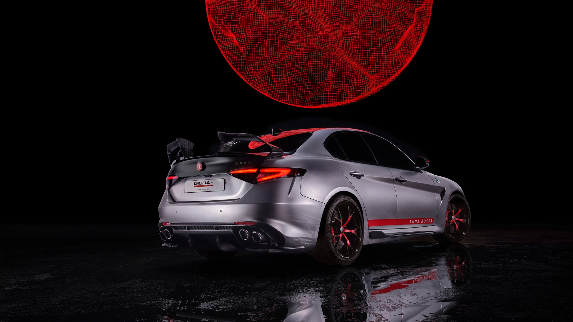 Giulia Luna Rossa pictured from behind in front of a large red sphere