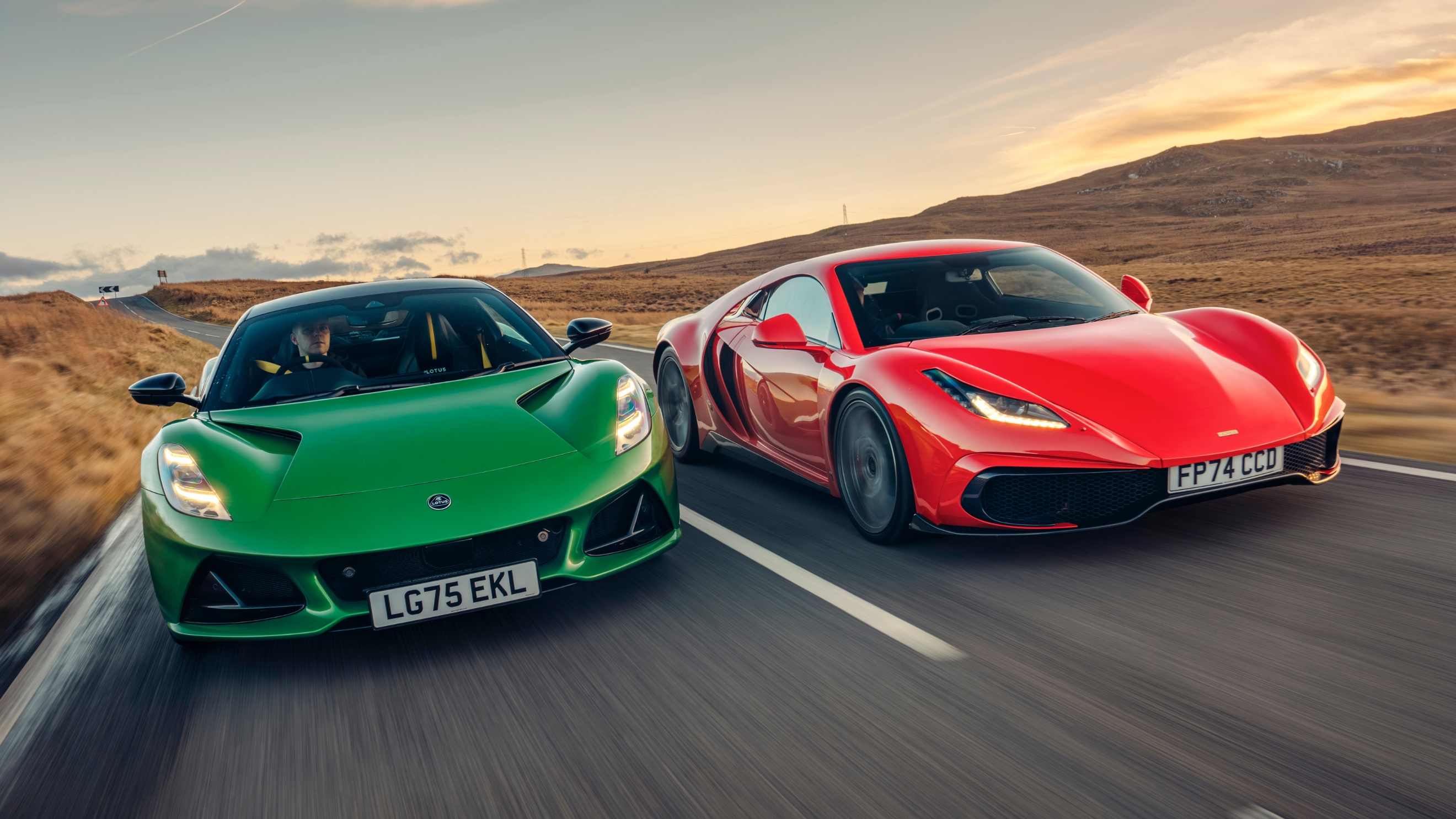 Noble M500 and Lotus Emira driving on a road pictured from the front