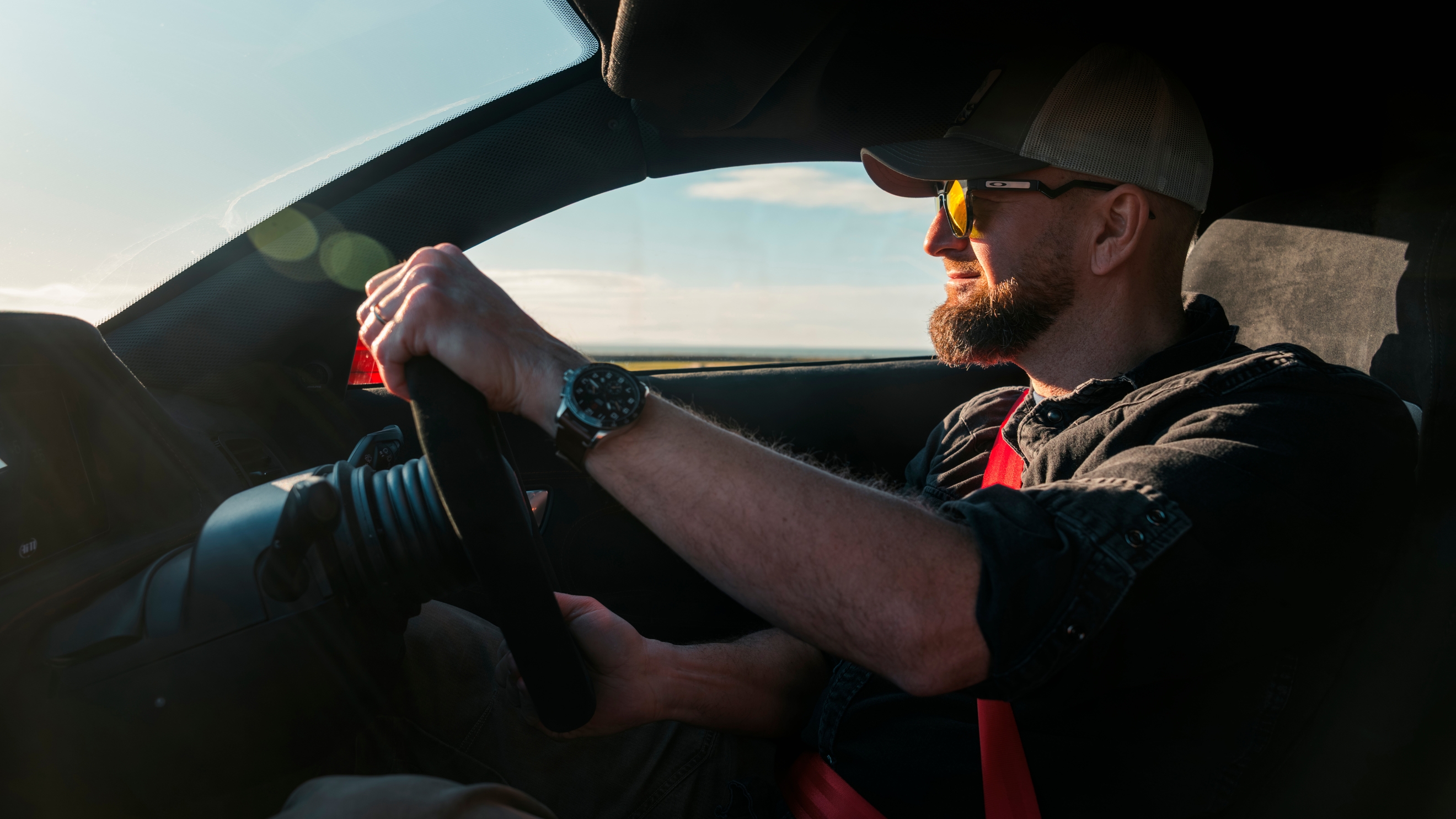 Driver pictured holding steering wheel of Noble M500